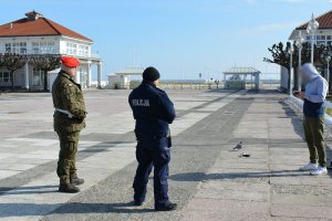 policjant z żołnierzem rozmawiają z osobą